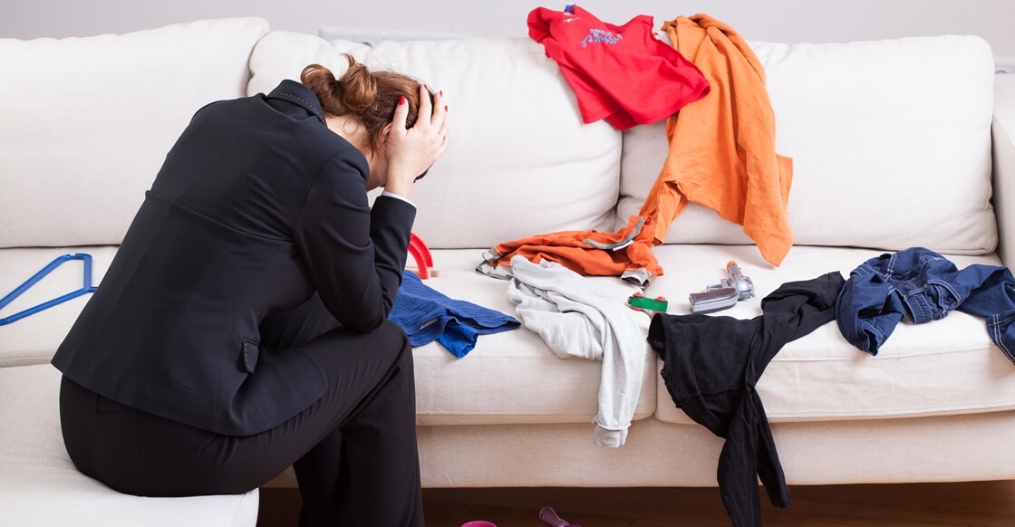 Women stressed in a cluttered room.