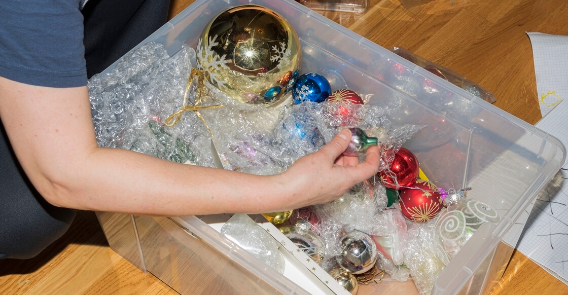 Storing Christmas decorations inside a plastic box.