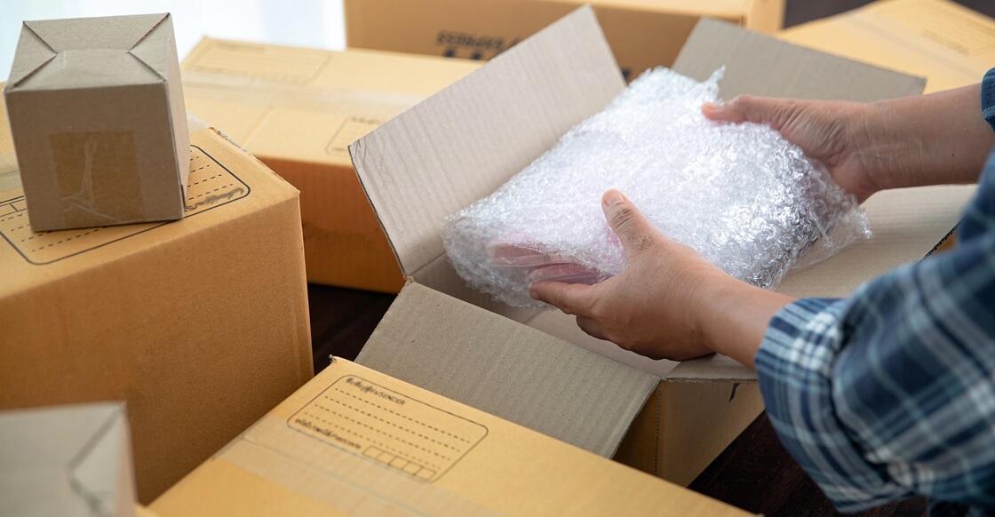 Man packing valuables for storage.