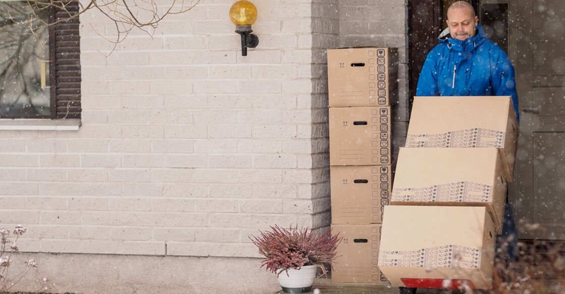 Man moving boxes to self storage during Winter.