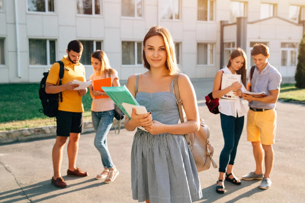 handsome-young-girl-with-red-velvet-backpack-holding-books